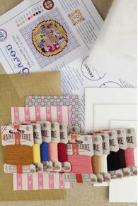 Detailed contents of the Sajou Little Girl and her Cat needlepoint kit to make stuffed puffies