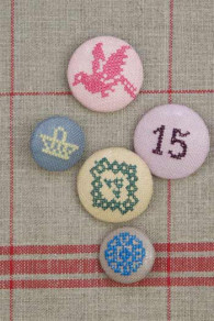 Various Sajou metal button models covered with cross stitch embroidery