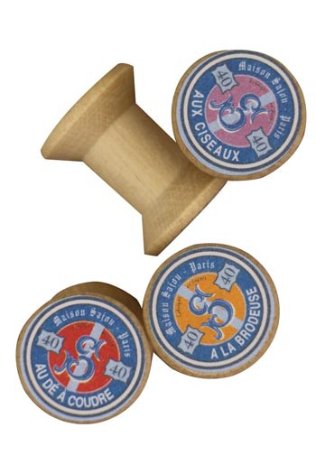 4 miniature wooden bobbins with "Maison Sajou" labels 4 miniature wooden bobbins with "Maison Sajou" labels