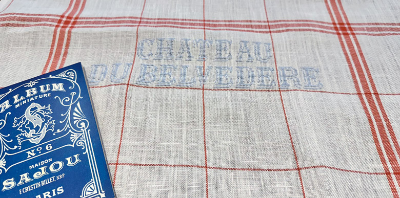 Ecru and orange Sajou tea towel embroidered with CHÂTEAU DU BELVÉDÈRE